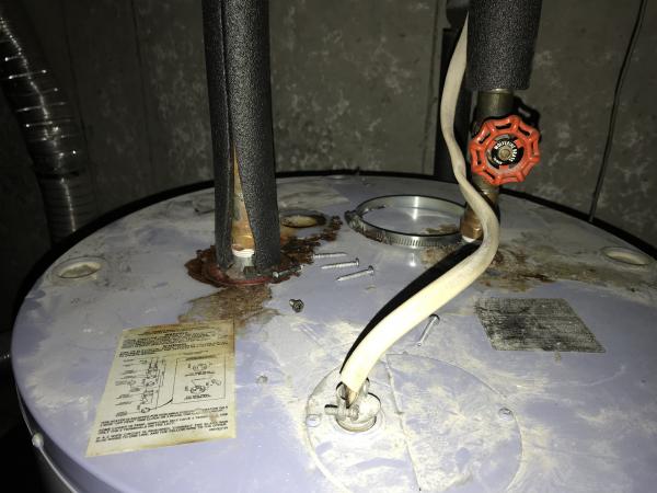  gas water heater leaks from top